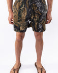 Person wearing real tree camouflage day shorts on a white background