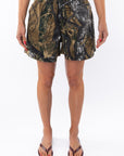 Woman wearing real tree camo day shorts on a white background