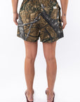 Back view of a woman wearing real tree camo day shorts