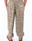 Back shot of a man wearing Leopard Camo day pants.