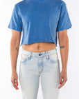 Woman wearing Beach Crop Tee in Blue Wave with Surf Jeans.