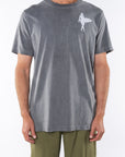 Man wearing Surfer Girl Graphic T-shirt in Sea Gray with Army Green day pants.