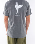 Back shot of a man wearing Surfer Girl Graphic T-shirt in Sea Gray with Army Green day pants.