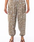 Woman wearing Leopard Camo day pants on a white background