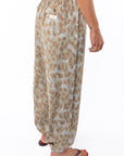 Back side shot of a woman wearing Leopard printed pants on a white background.