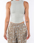 Woman wearing a Scallop Tank in Sandstone with Leopard Camo Day pants.