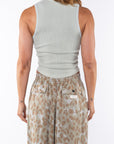 Back shot of a woman wearing a Scallop Tank in Sandstone with Leopard Camo Day pants.