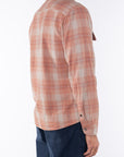 Side back shot of a man wearing a lightweight Plaid shirt in Orange/Blue with navy pants on a white background.