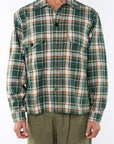 Man wearing Bucky Flannel Over shirt in Green/Brown with army green day pants.