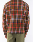 Back shot of a man wearing Bucky Flannel Over shirt in Brown/Red with army green day pants