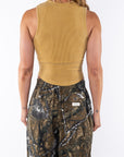 Back shot of a woman wearing Scallop Tank in Sunrise Yellow with Real Tree camo day pants