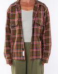 Woman wearing the Bucky Flannel Over shirt in brown/red with Surf Tank in Sandstone and army green day pants.