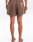 Back view of french terry brown day shorts worn on a white background