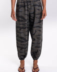 Woman wearing Ocean Tiger Camouflage pants worn on a white background