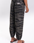 Side back view of ocean tiger camo pants worn by a person on a white background