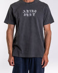 Person wearing a dark gray t-shirt with 'ARIKO Surf' logo on a white background