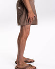 Brown french terry day shorts worn by a person on a white background