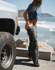 woman beach crop t-shirt in teal while putting on ocean tiger camo day pants at the beach parking lot
