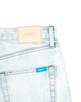 detail shot of backside of 'ARIKO' denim pockets and denim branding