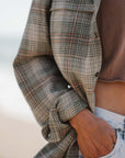 Detail shot of summer softy plaid shirt in green/red with model wearing beach crop t-shirt in brownstone.