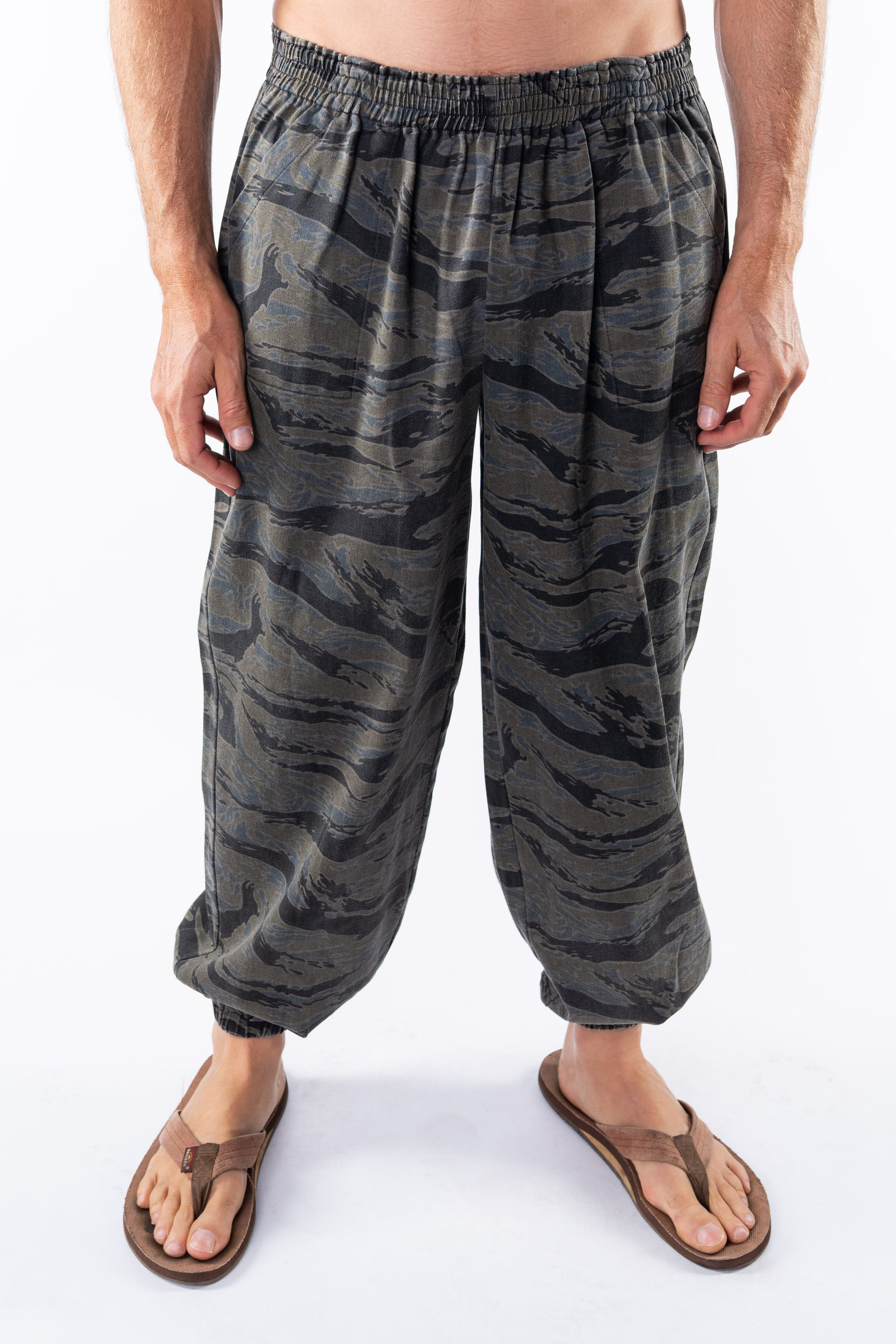 Ocean tiger camo day pants worn by a person on a white background