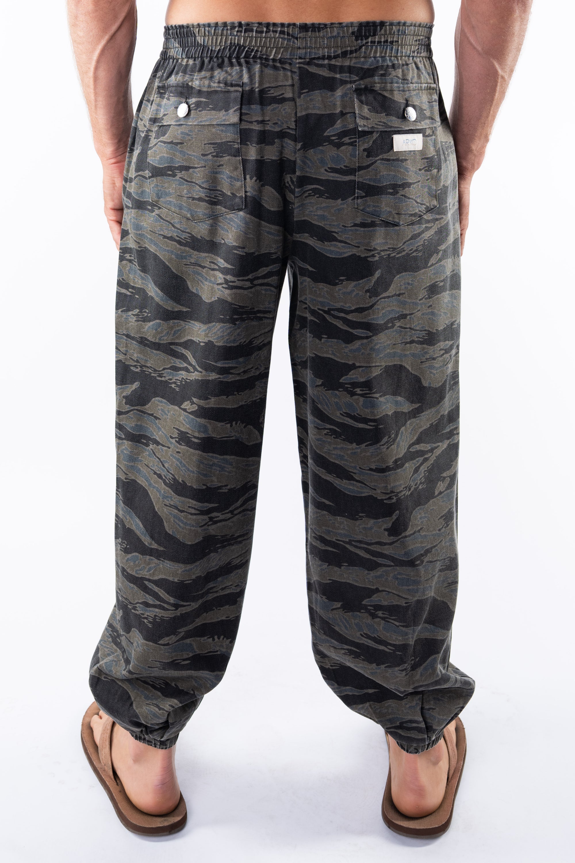 Back view of ocean tiger camo day pants worn by a person on a white background