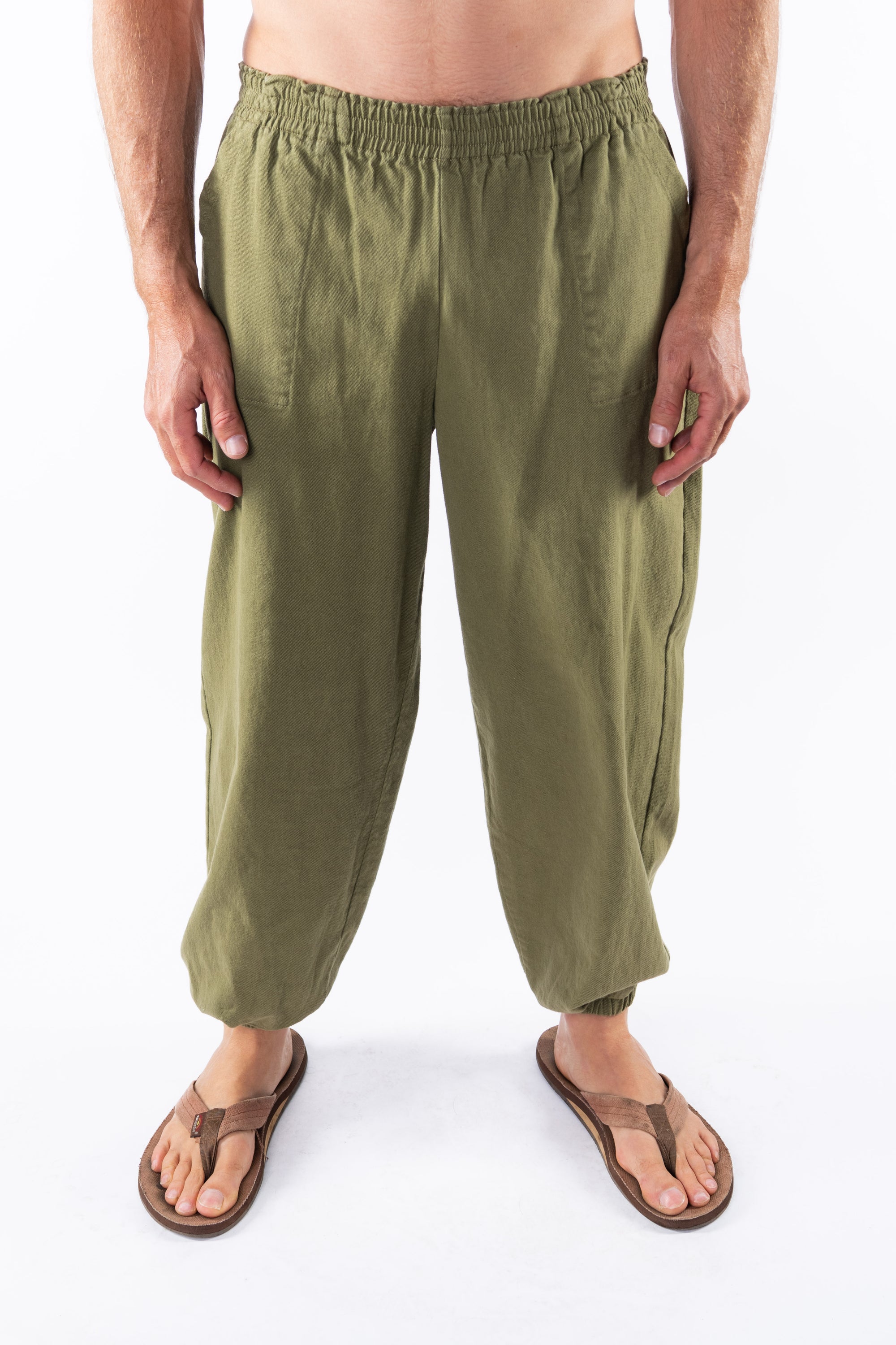 Person wearing army green day pants on a white background