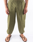 Person wearing army green day pants on a white background