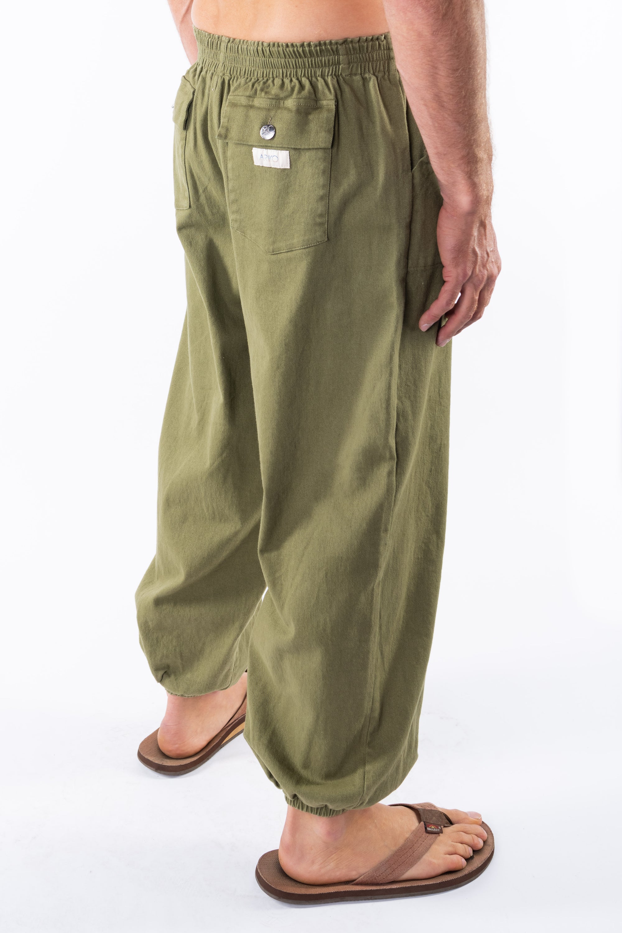 Side back view of army green day pants worn by a person on a white background