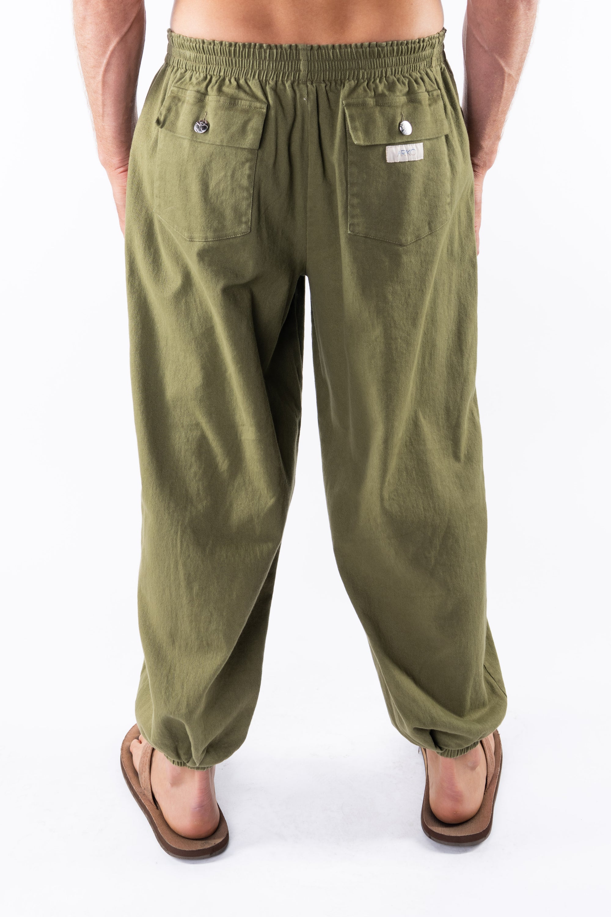 Back view of army green day pants worn by a person on a white background