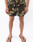 Person wearing camouflage day shorts on a white background