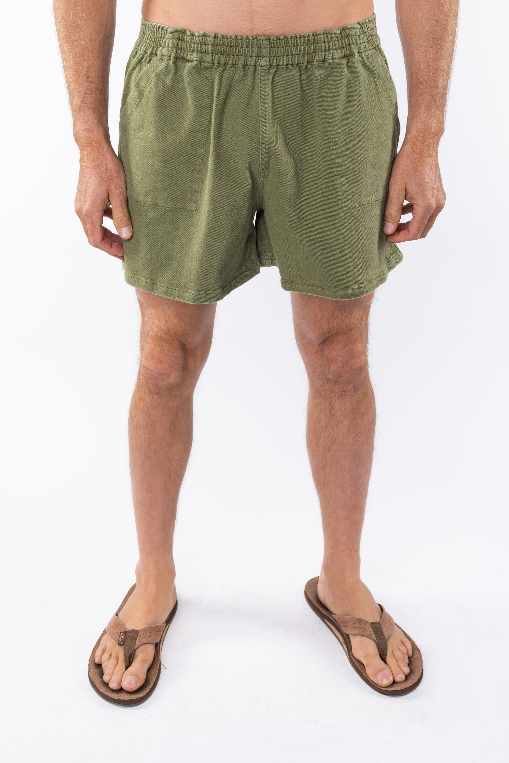 Army green day shorts worn by a person on a white background