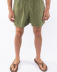 Army green day shorts worn by a person on a white background
