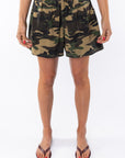 Woman wearing camouflage day shorts on a white background