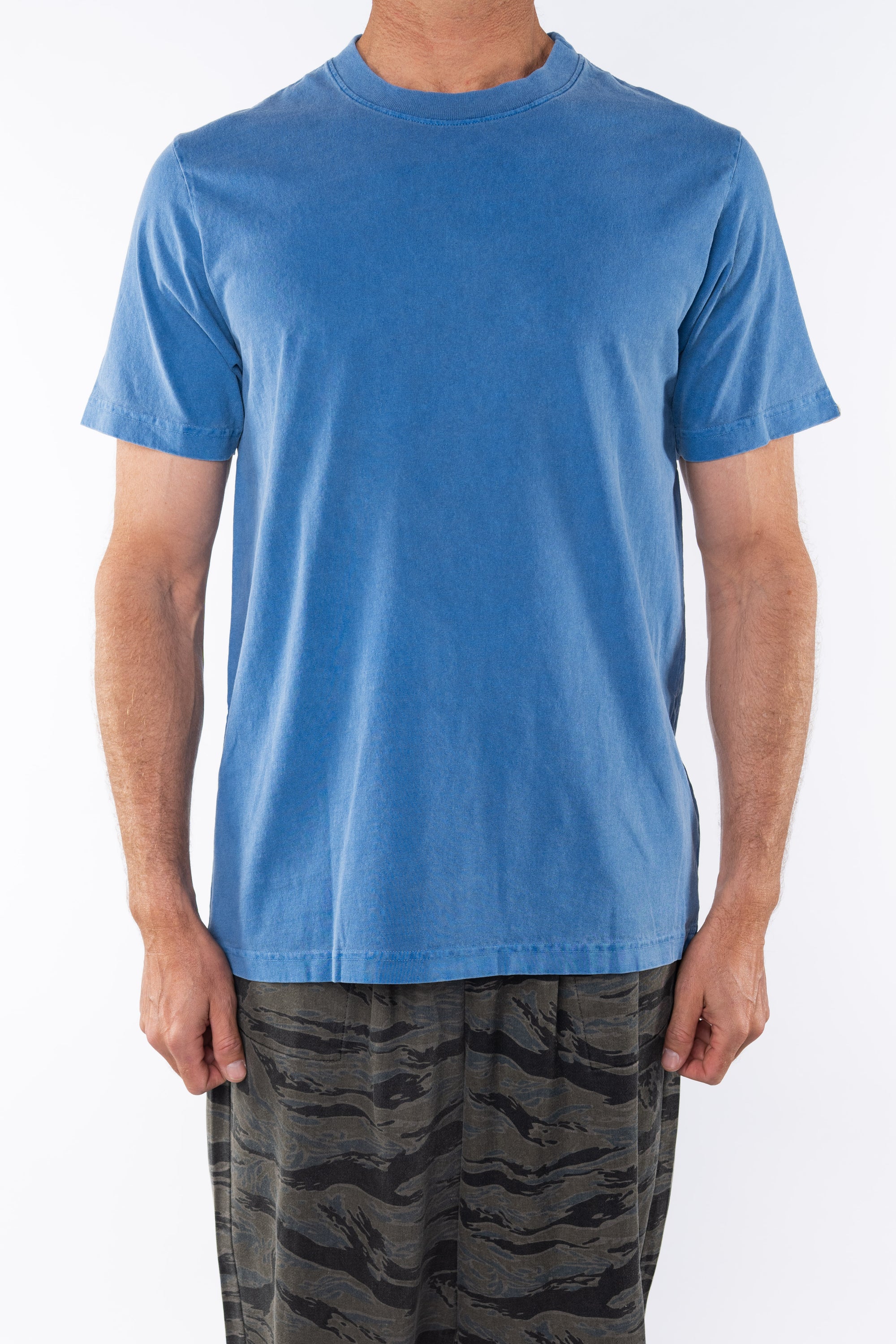 Man wearing Beach Crewneck T-shirt in Blue Wave with Ocean Tiger Camo day pants.