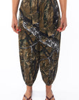 Woman wearing Real Tree Camo day pants. 