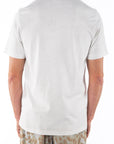 Back shot of man wearing a Crewneck T-shirt in cream with a leopard pants on a white background.