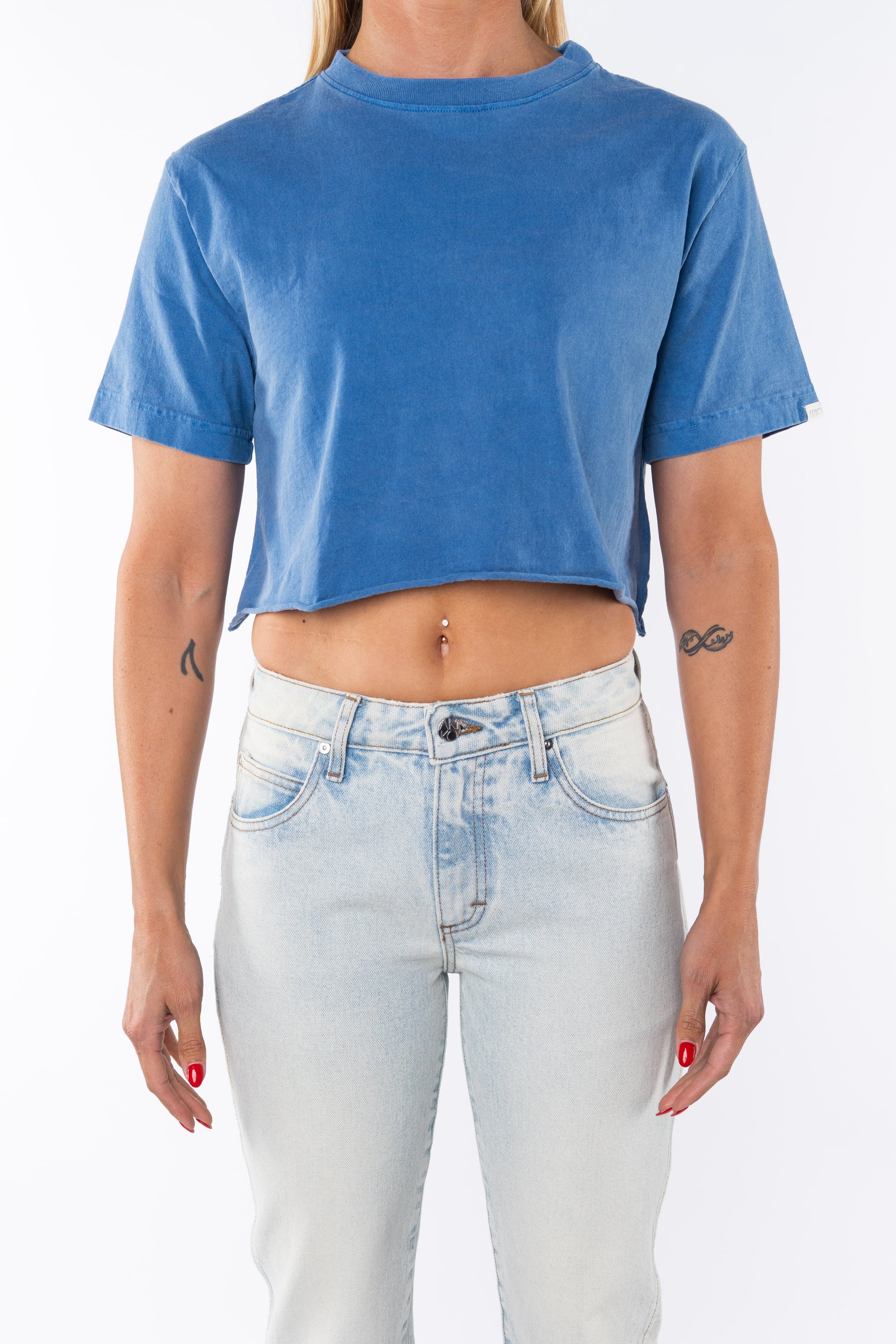 Woman wearing Beach Crop Tee in Blue Wave with Surf Jeans. 