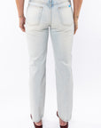 Light denim washed jeans worn by a woman on a white background