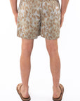 Back view of a man wearing leopard camo printed day shorts 