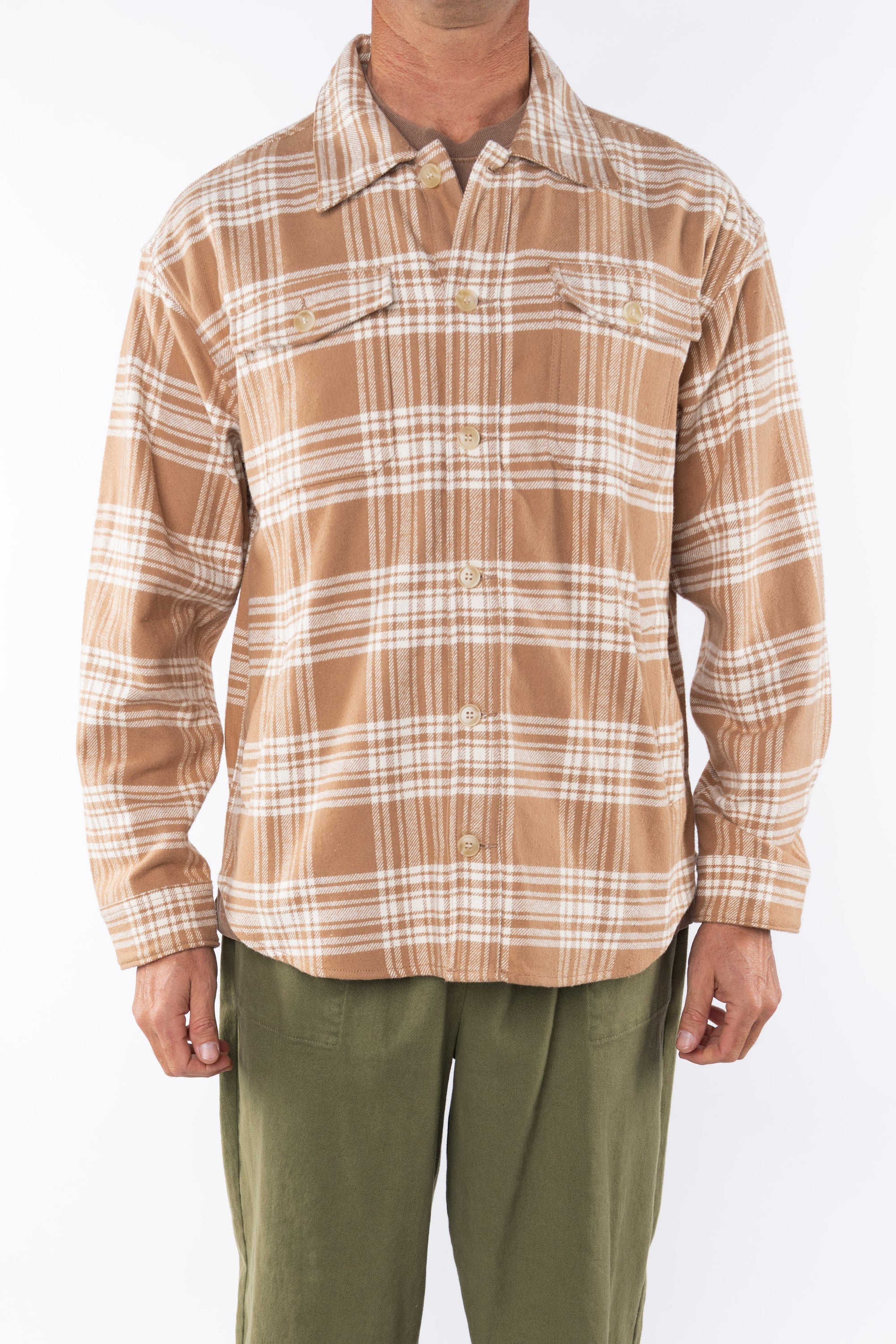 Man wearing Bucky Split Hem Shirt Jacket in White/Beige Plaid with Beach Crewneck T-shirt Brownstone with Army Green Day pants. 