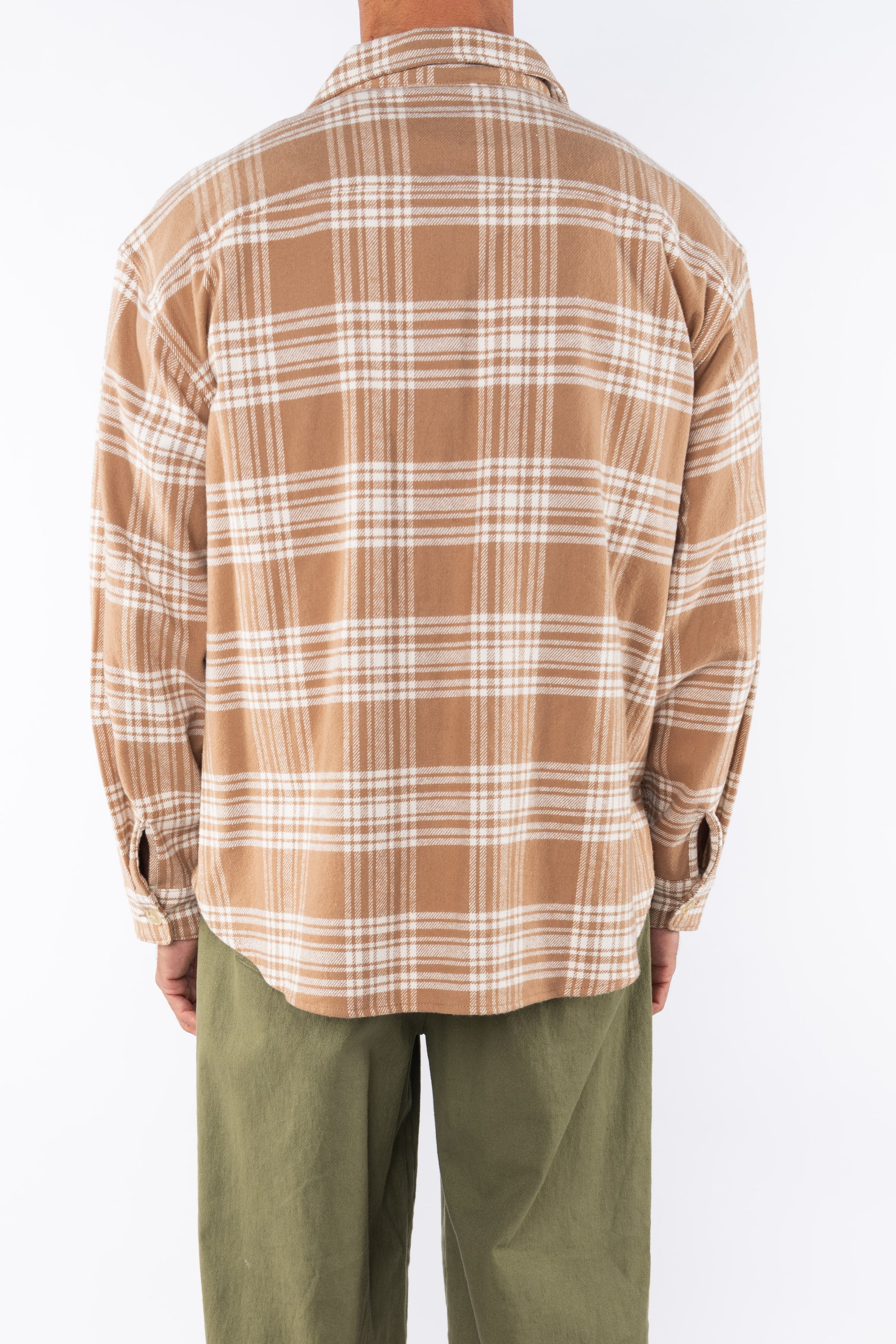 Back shot of a man wearing Bucky Split Hem Shirt Jacket in White/Beige Plaid with Army Green Day pants. 