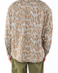 Back view of a person wearing a leopard camo bucky shirt jacket and army green day pants on a white background