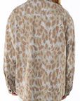 Back view of a woman wearing bucky Leopard camo print jacket worn by a person on a white background