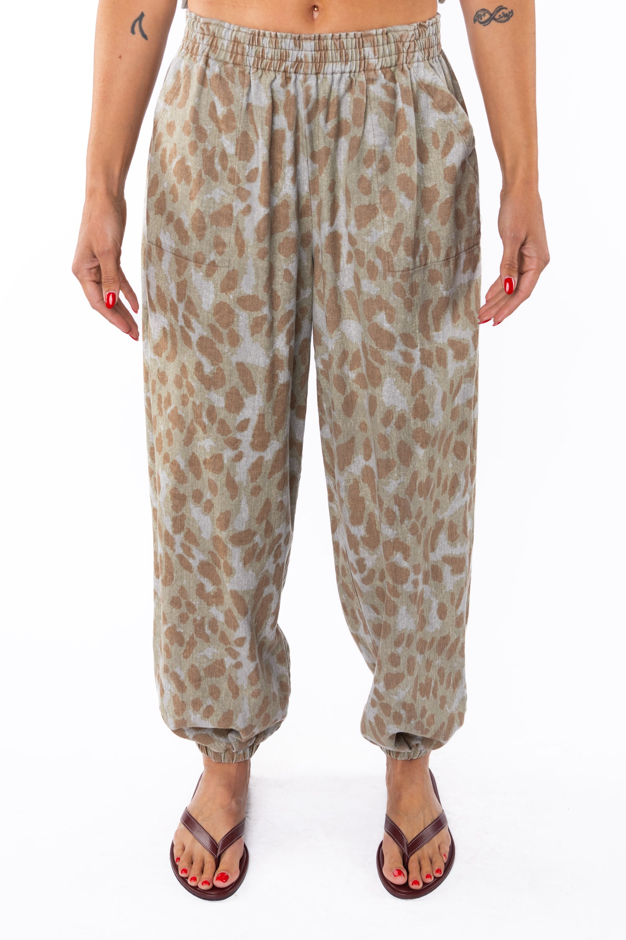 Woman wearing Leopard Camo day pants on a white background
