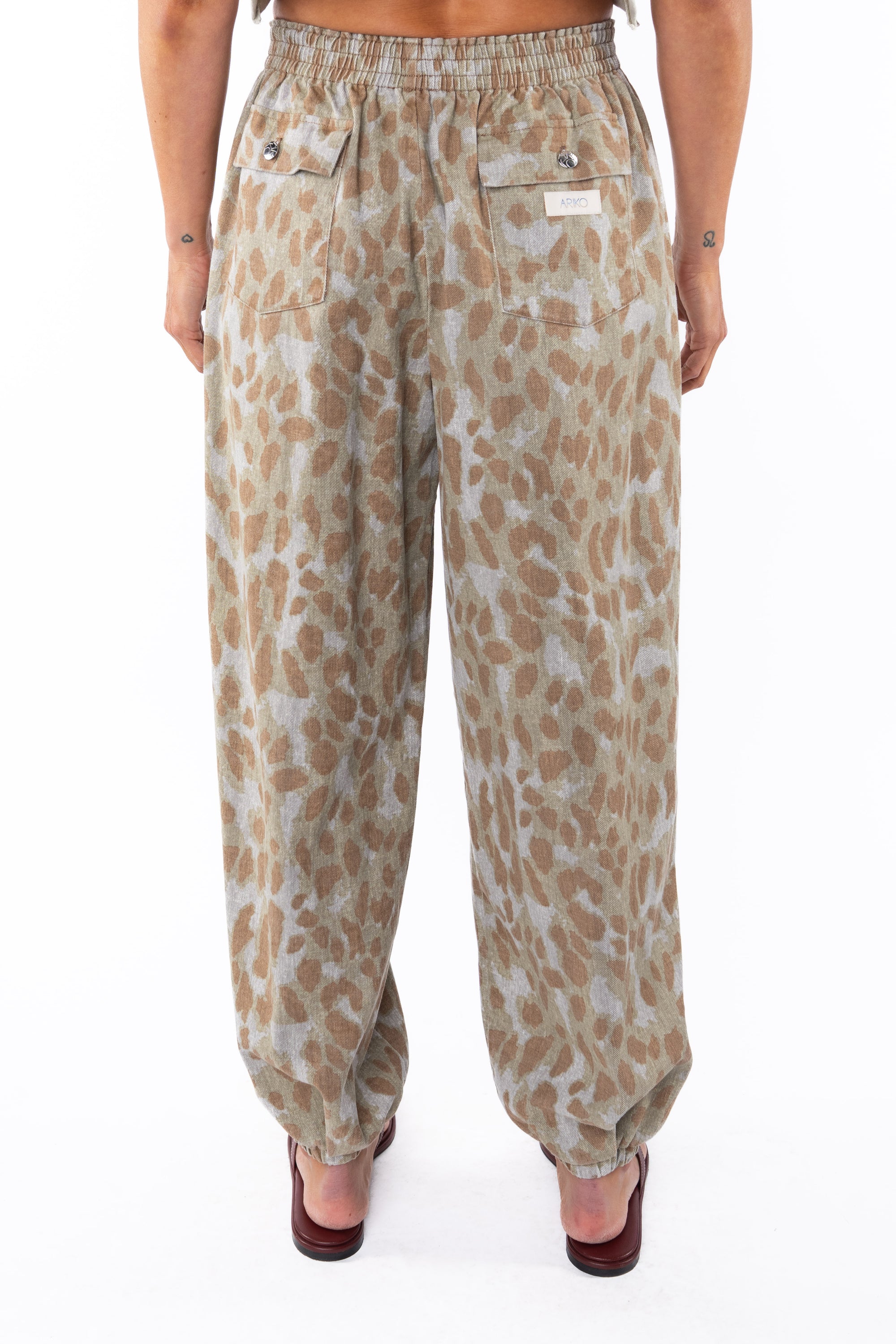 Back shot of a woman wearing leopard camo day pants. 
