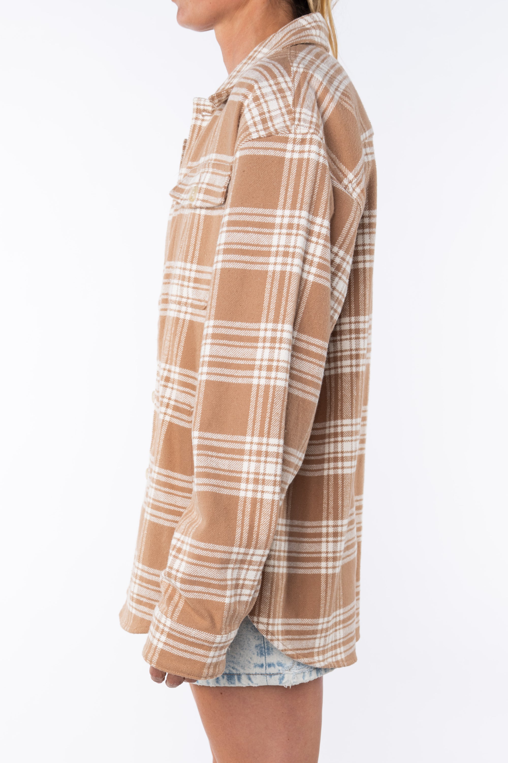 Side shot of a woman wearing a Shirt Jacket in Beige/White Plaid with the Denim mini Skirt on a white background. 