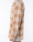 Side shot of a woman wearing a Shirt Jacket in Beige/White Plaid with the Denim mini Skirt on a white background. 