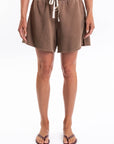 Woman wearing brown french terry day shorts worn by a person on a white background