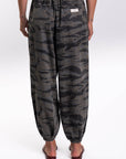 Back view of a woman wearing Ocean Tiger Camouflage pants worn on a white background